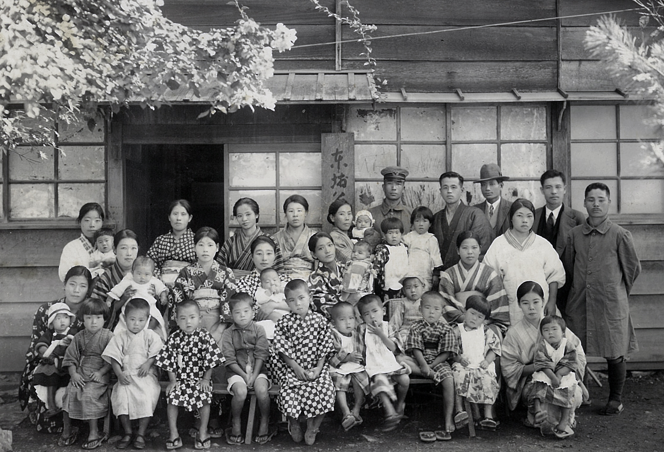張春鐘與友人在東埔公學校前與駐在所警察、公學校教職員、學童及保育園的保母、幼兒合照